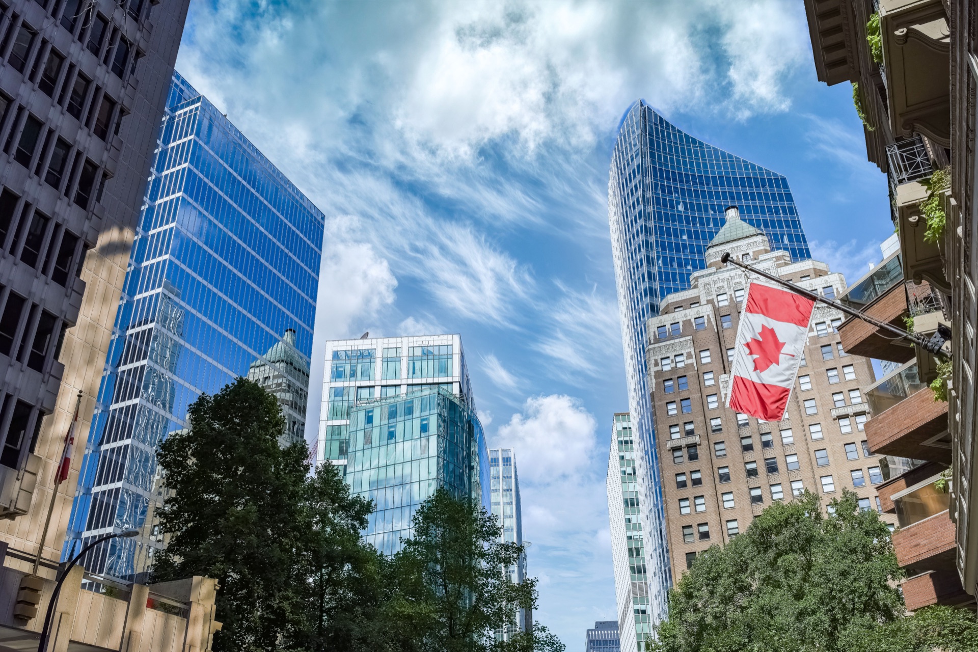 Canadian flag outside modern office buildings