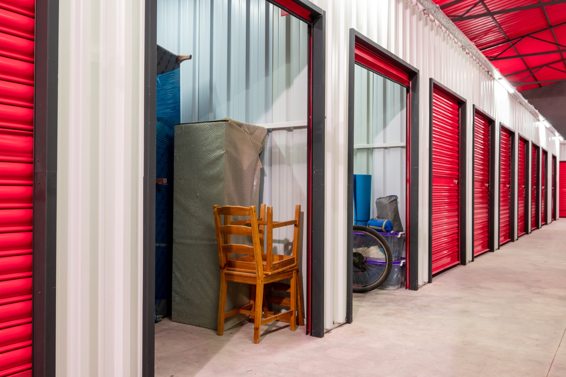 Storage units with wrapped furniture and moving boxes